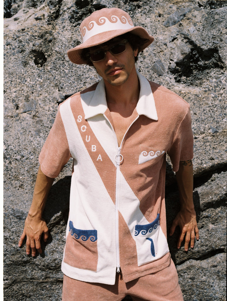 This three-piece set, made from 100% organic cotton terry cloth, includes waves, fish, and 'SCUBA' embroidery, along with matching pants and a bucket hat
