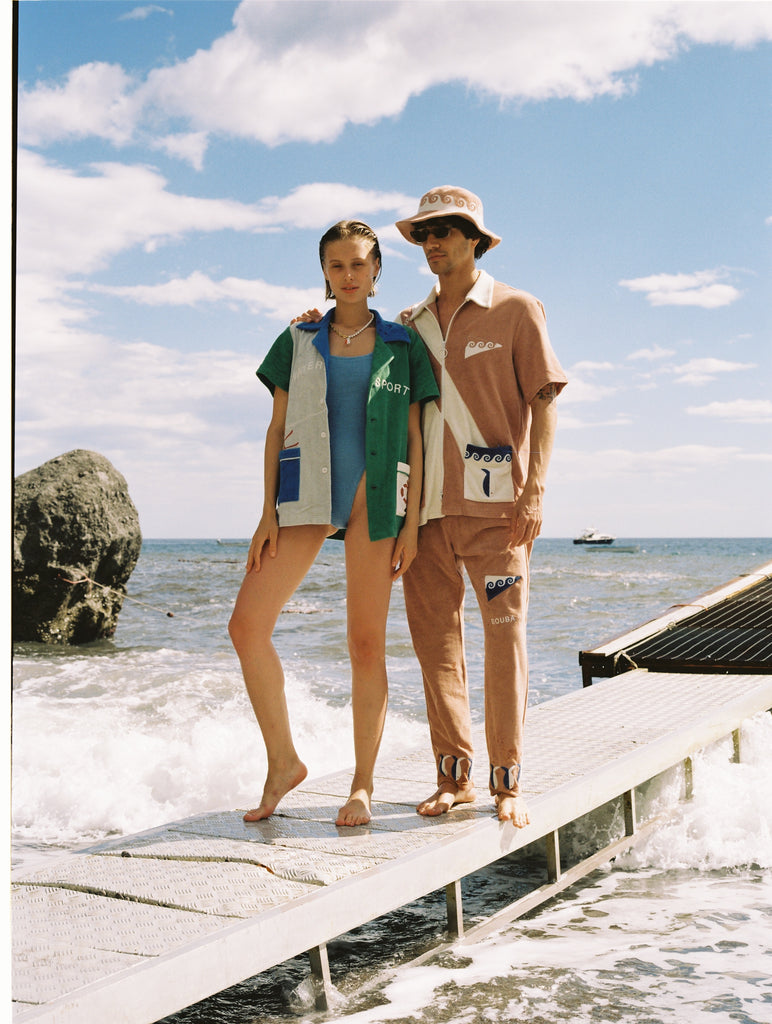Crafted from 100% organic cotton terry cloth, this three-piece set includes waves, fish, and 'SCUBA' embroidery, as well as matching pants and a bucket hat.