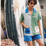 Male model in full set leaning against boat