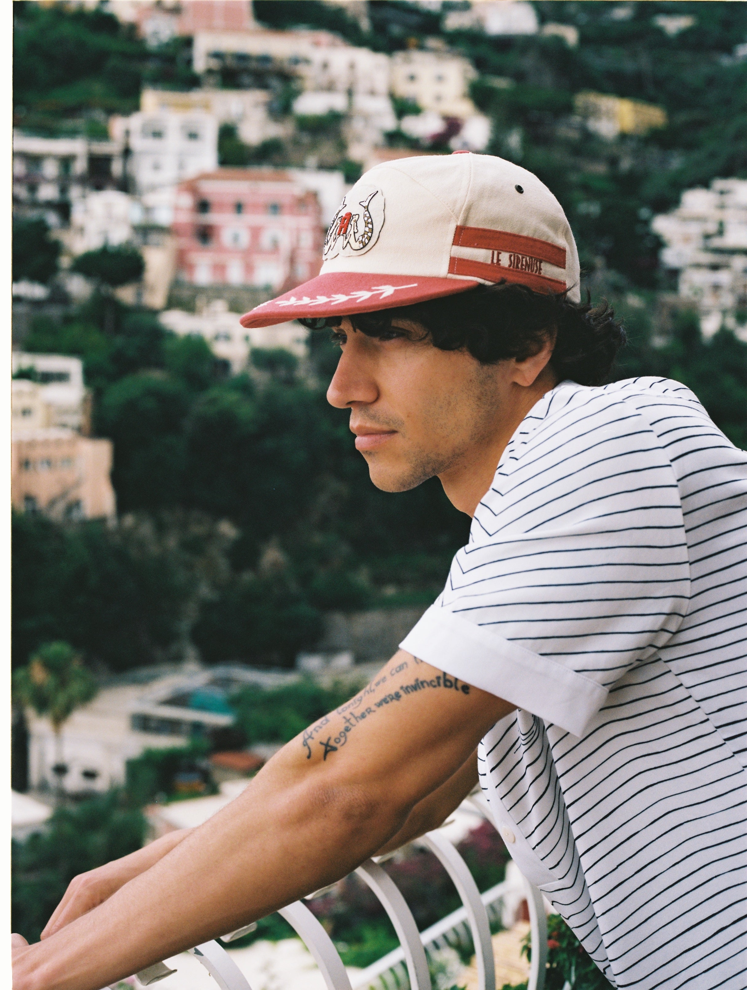 Male model wearing hat looking out in Positano, Italy