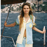 Female model wearing full limoncello set with only top button of shirt buttoned