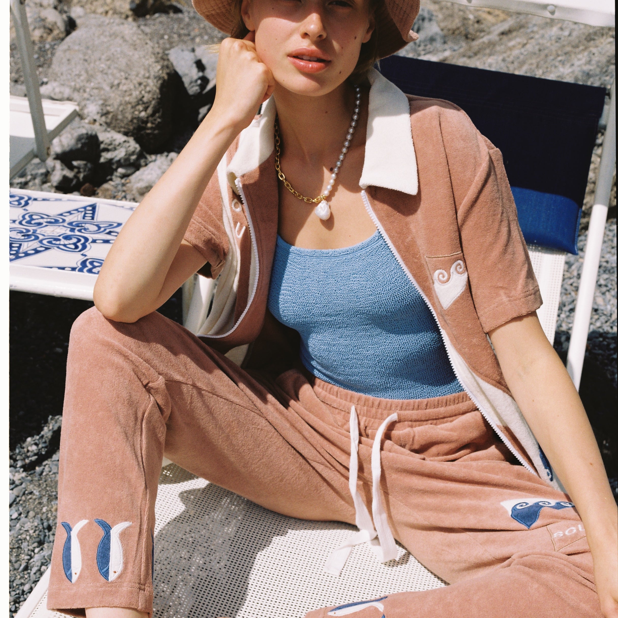 Featuring waves, fish, and 'SCUBA' embroidery, this three-piece set is crafted from 100% organic cotton terry cloth, and includes matching pants and a bucket hat