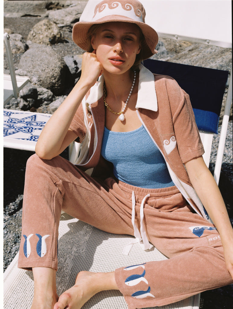 Featuring waves, fish, and 'SCUBA' embroidery, this three-piece set is crafted from 100% organic cotton terry cloth, and includes matching pants and a bucket hat