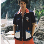 Male model wearing cabana looking at camera with hands in pockets