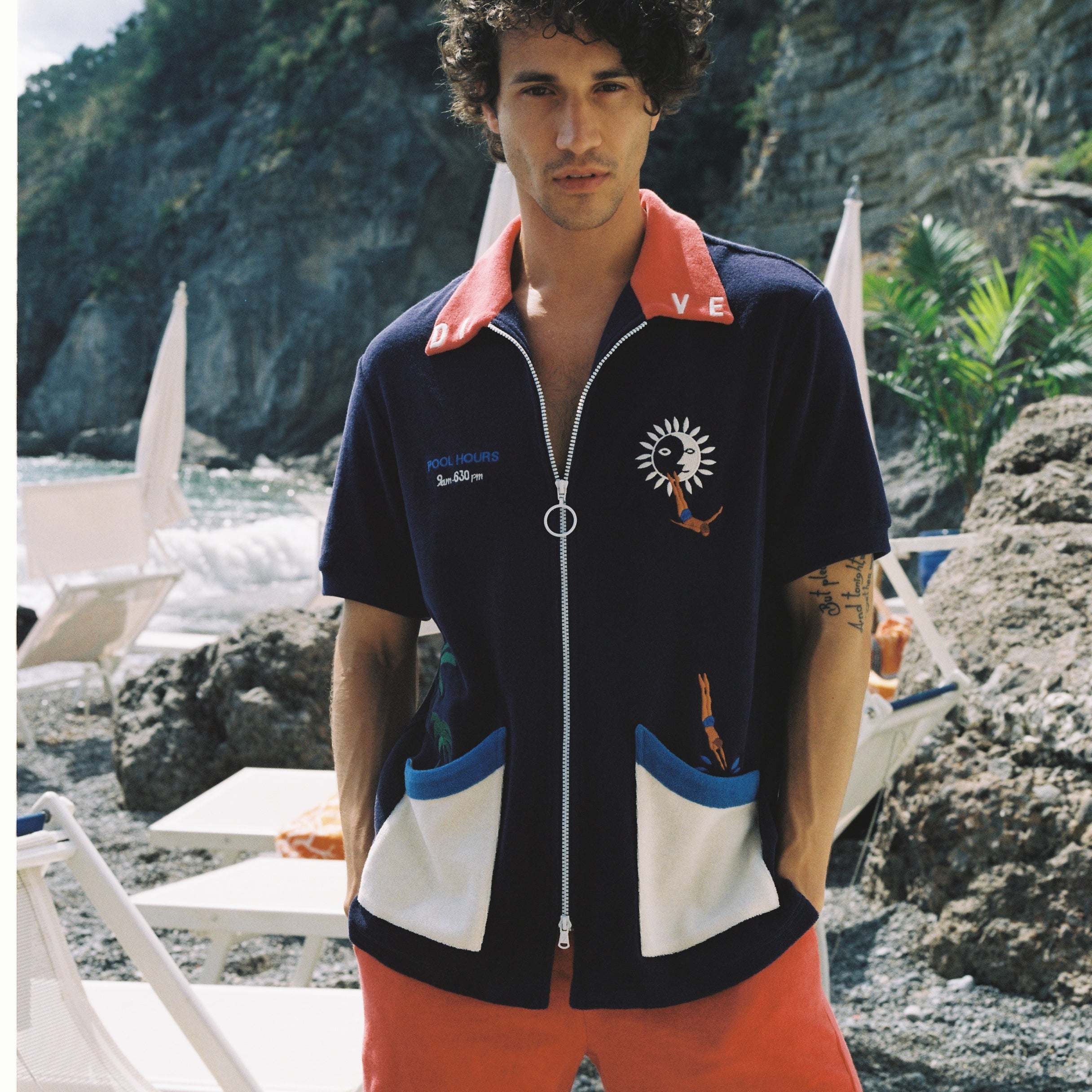 Male model wearing cabana looking at camera with hands in pockets