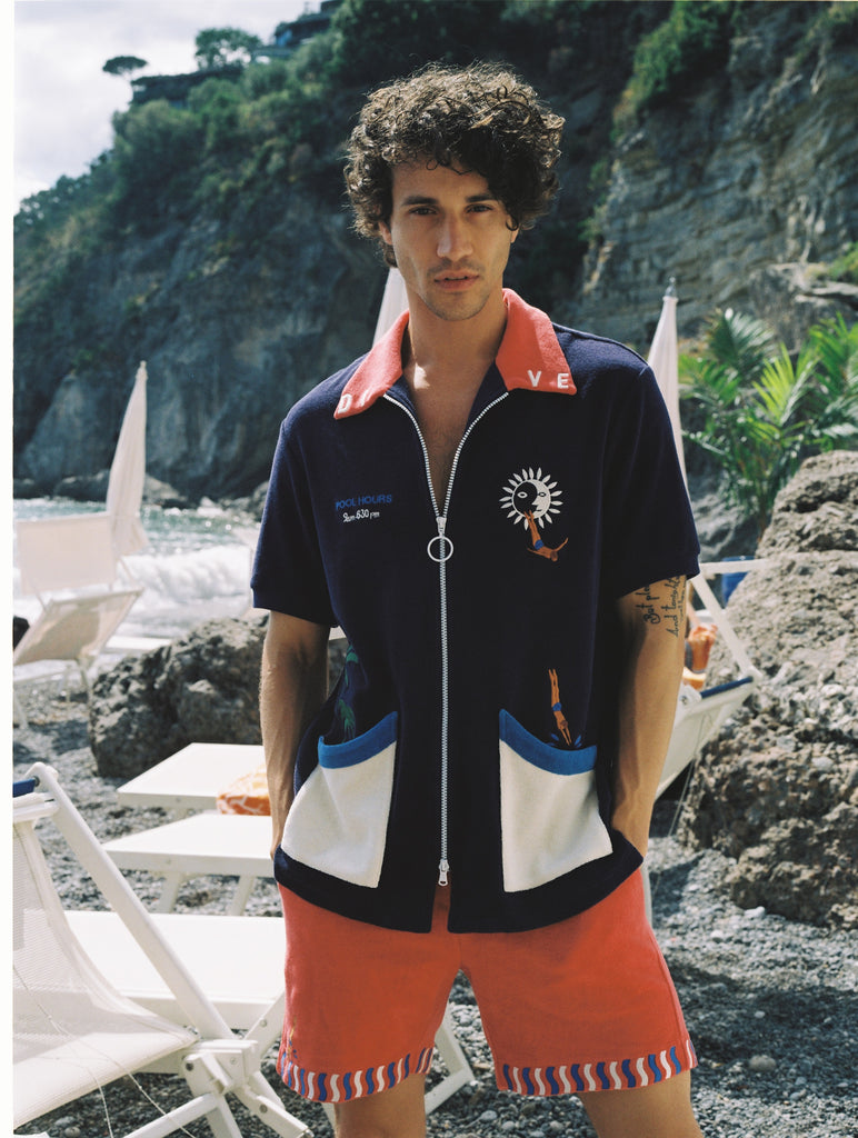 Male model wearing cabana looking at camera with hands in pockets