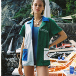 Female model wearing the cabana open over a swimsuit on the beach