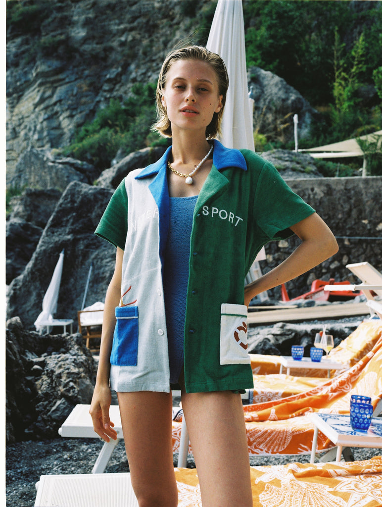 Female model wearing the cabana open over a swimsuit on the beach