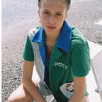 Female model looking up at camera sitting in cabana shirt