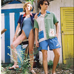 Female model with arm resting on male model wearing the full water sport sets shoulder