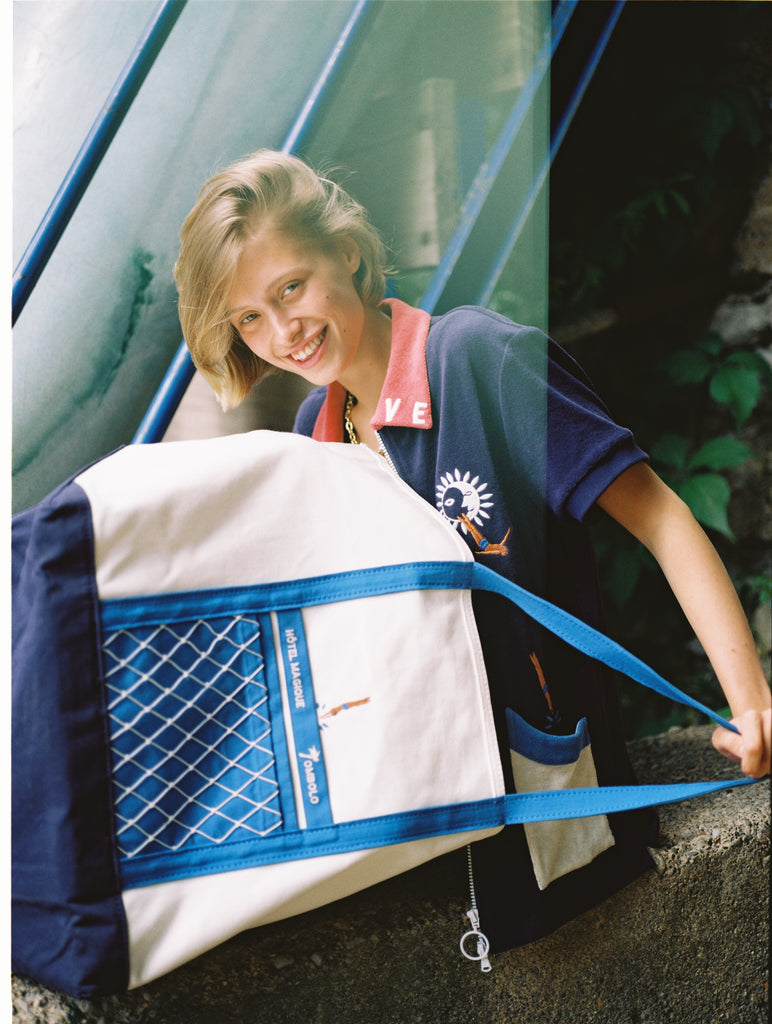 female model holding tote bag in her lap