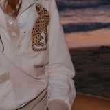 Artsy image of female model in the cabana wearing shell jewelry