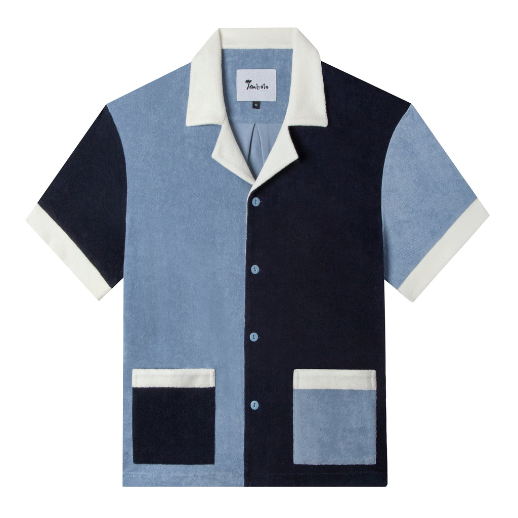 front lay flat product photo of navy, blue, and white color blocked cabana shirt
