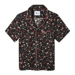 flat lay product photo of hawaiian top with recurring blue and red cat eye pattern and red, white, and blue piping