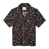 flat lay product photo of hawaiian top with recurring blue and red cat eye pattern and red, white, and blue piping