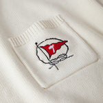 Close up of embroidered red flag with Tombolo logo on pocket