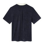 Back of navy Tombolo polo showing back pleating