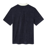 Back of navy Tombolo polo showing back pleating