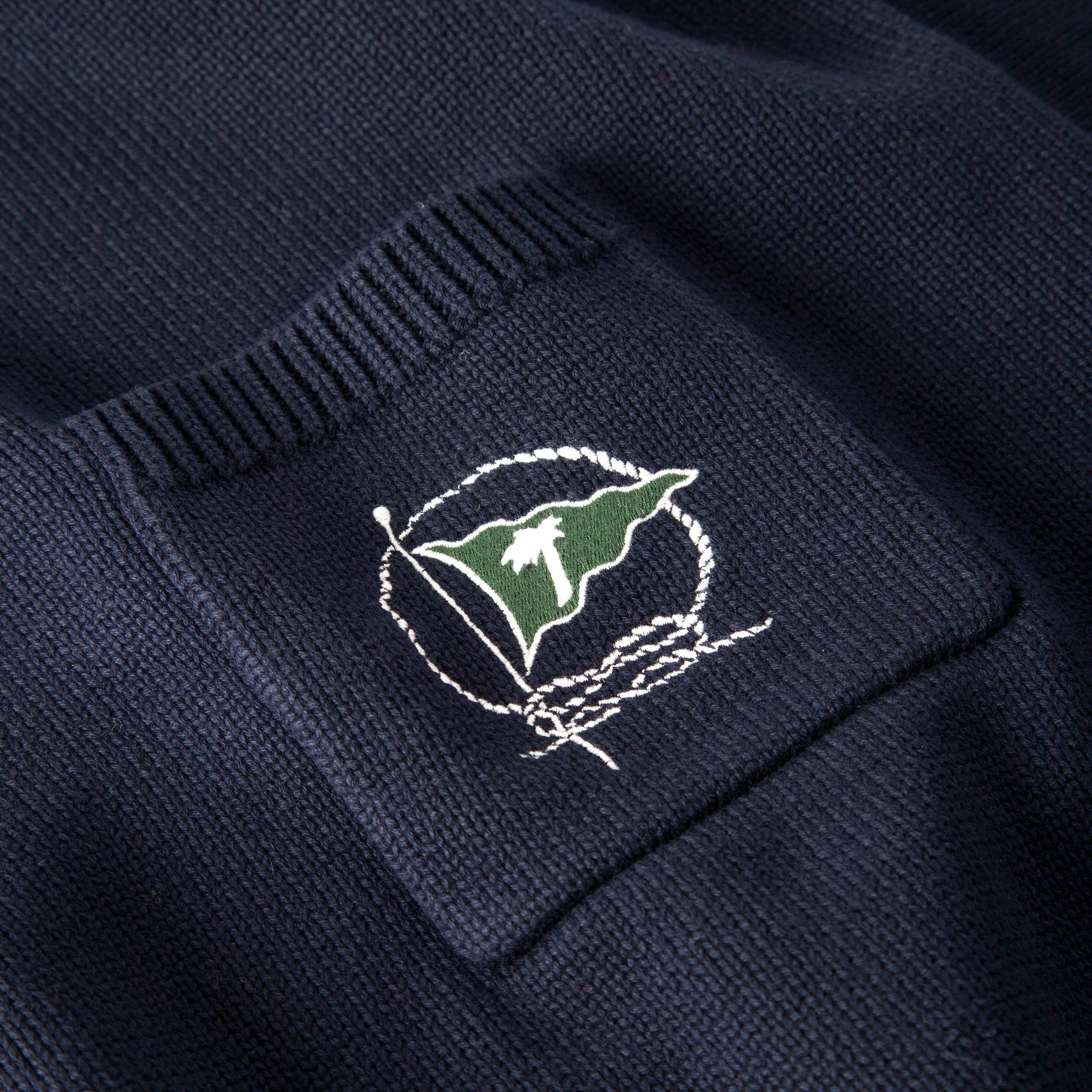 Close up of embroidered green flag
