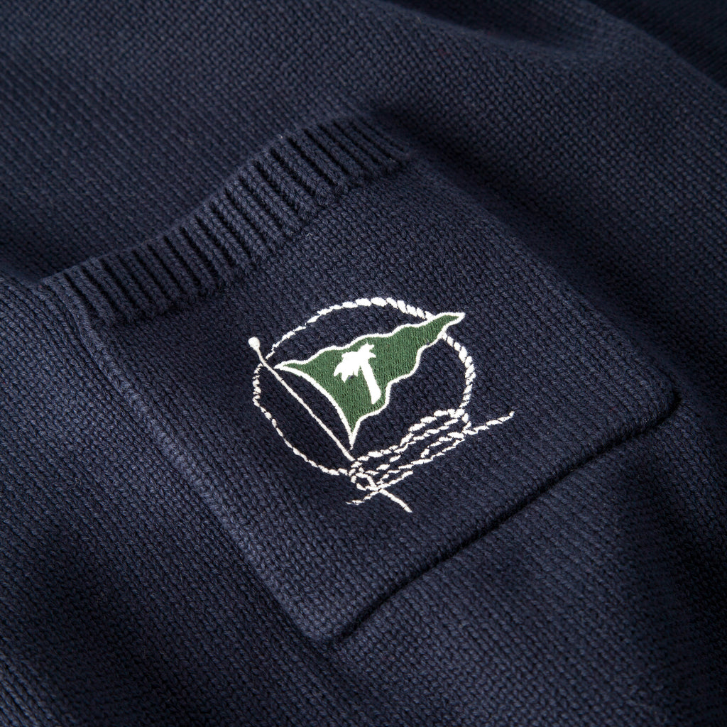 Close up of embroidered green flag