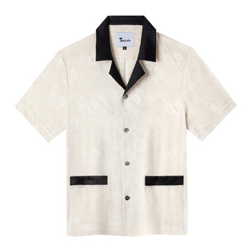 Front view of this champagne colored shirt made with a jacquard fabric featuring a collar and pocket strips in a black linen combination fabric and four Agoya shell buttons