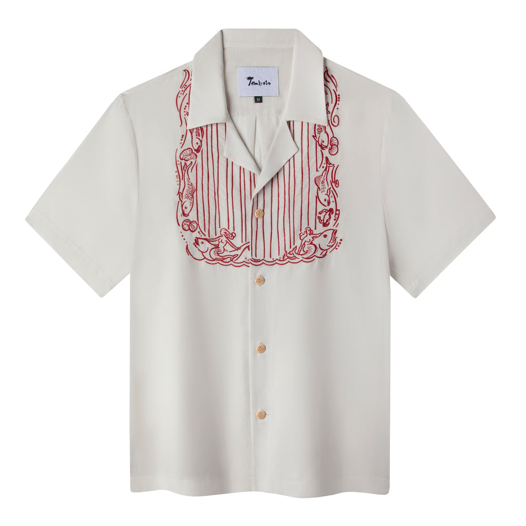 Front view of the white fruits de mer shirt featuring a red embroidered bib pattern with sea creatures on the border and stripes in the middle