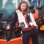 Female model in full set leaning on snow plow