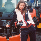 Female model in full set leaning on snow plow