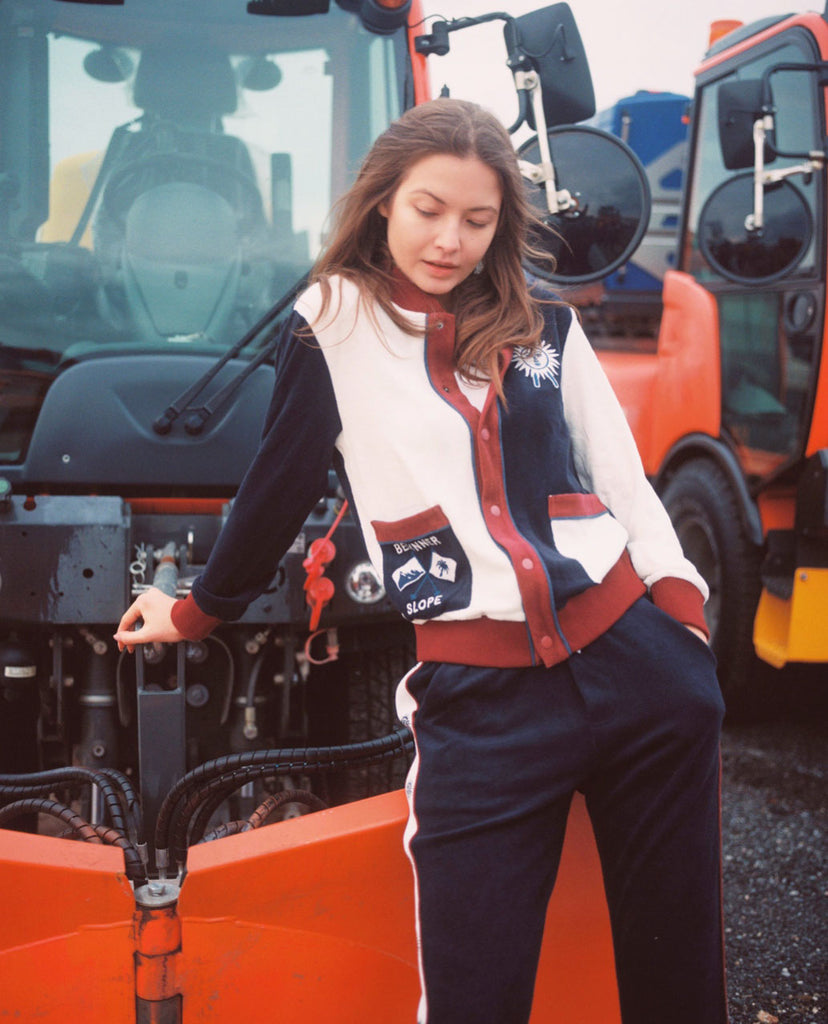 Female model in full set leaning on snow plow