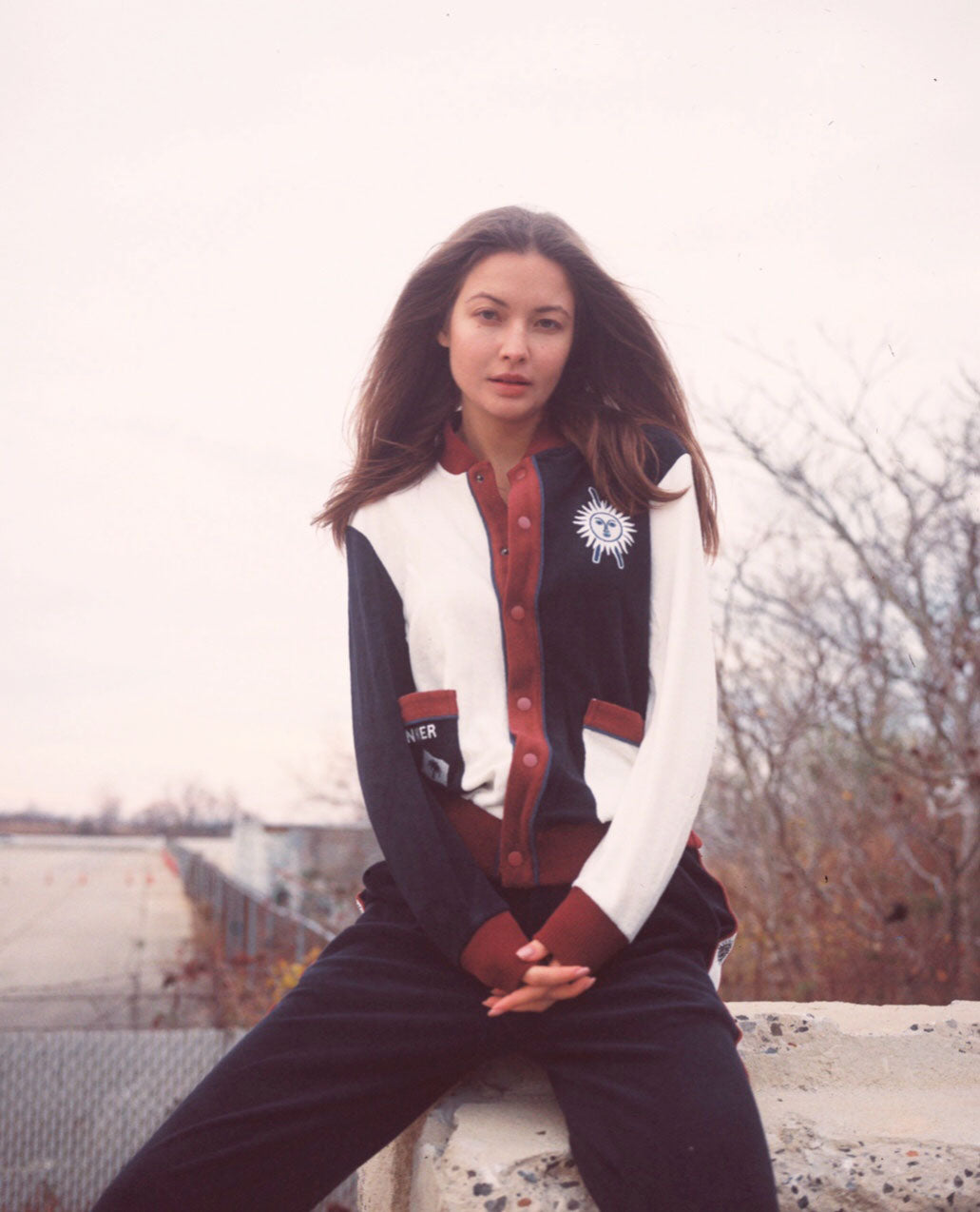 Female model wearing full set sitting on a ledge