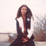 Female model wearing full set sitting on a ledge