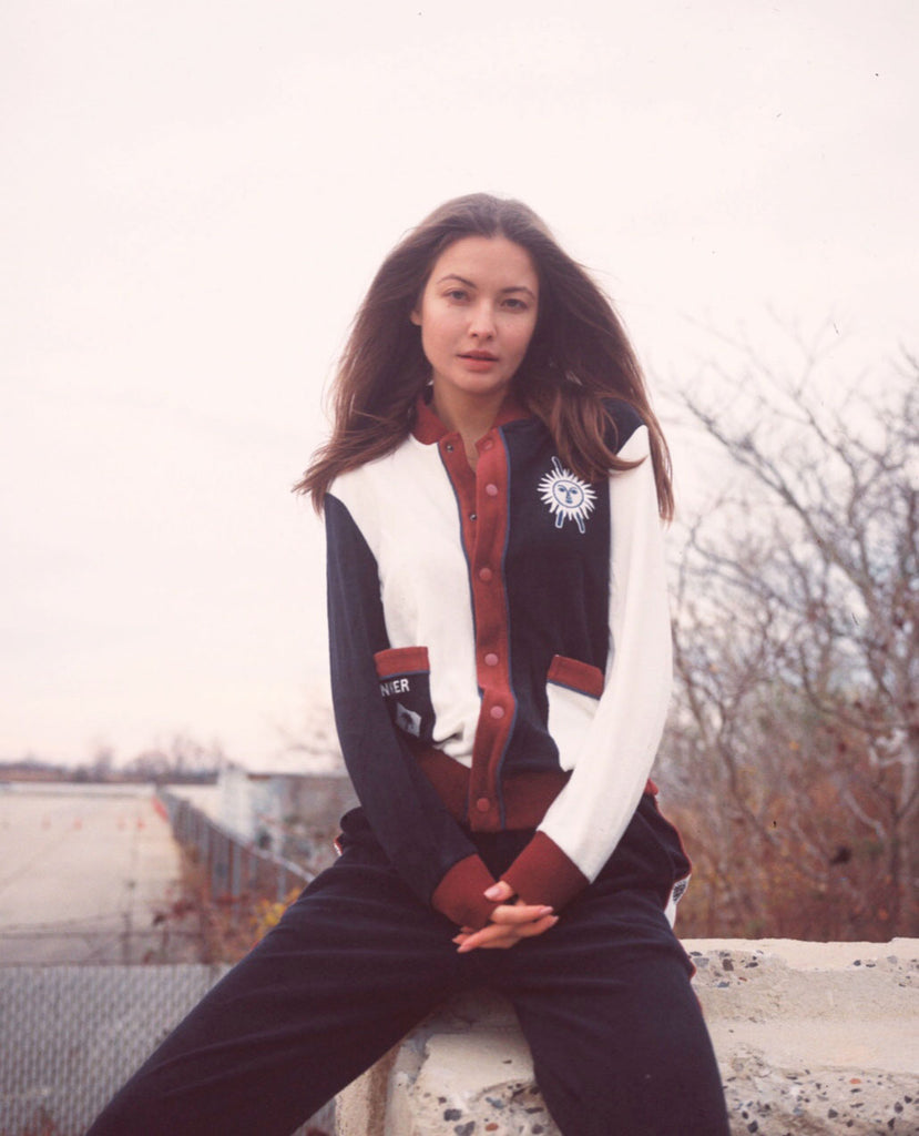 Female model wearing full set sitting on a ledge