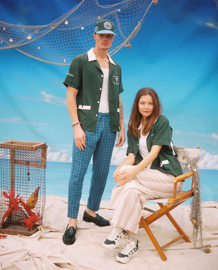 Male and female models posing in shirt, one standing and the other sitting