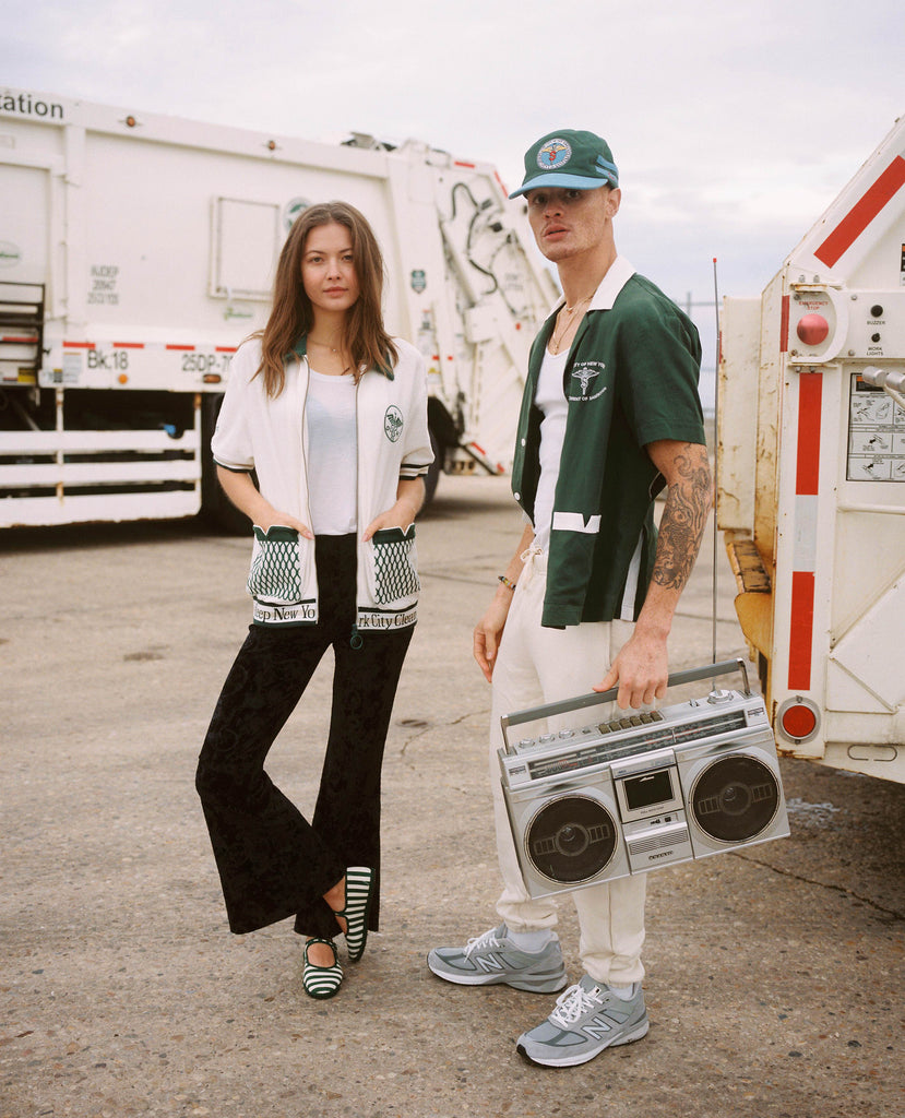 Female model in dsny cabana next to male model in dsny hawaiian and hat