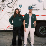 Female model wearing the DSNY x Tombolo sweater next to the male model in the DSNY short and hat