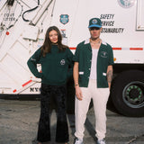 Female model wearing the DSNY x Tombolo sweater next to the male model in the DSNY short and hat