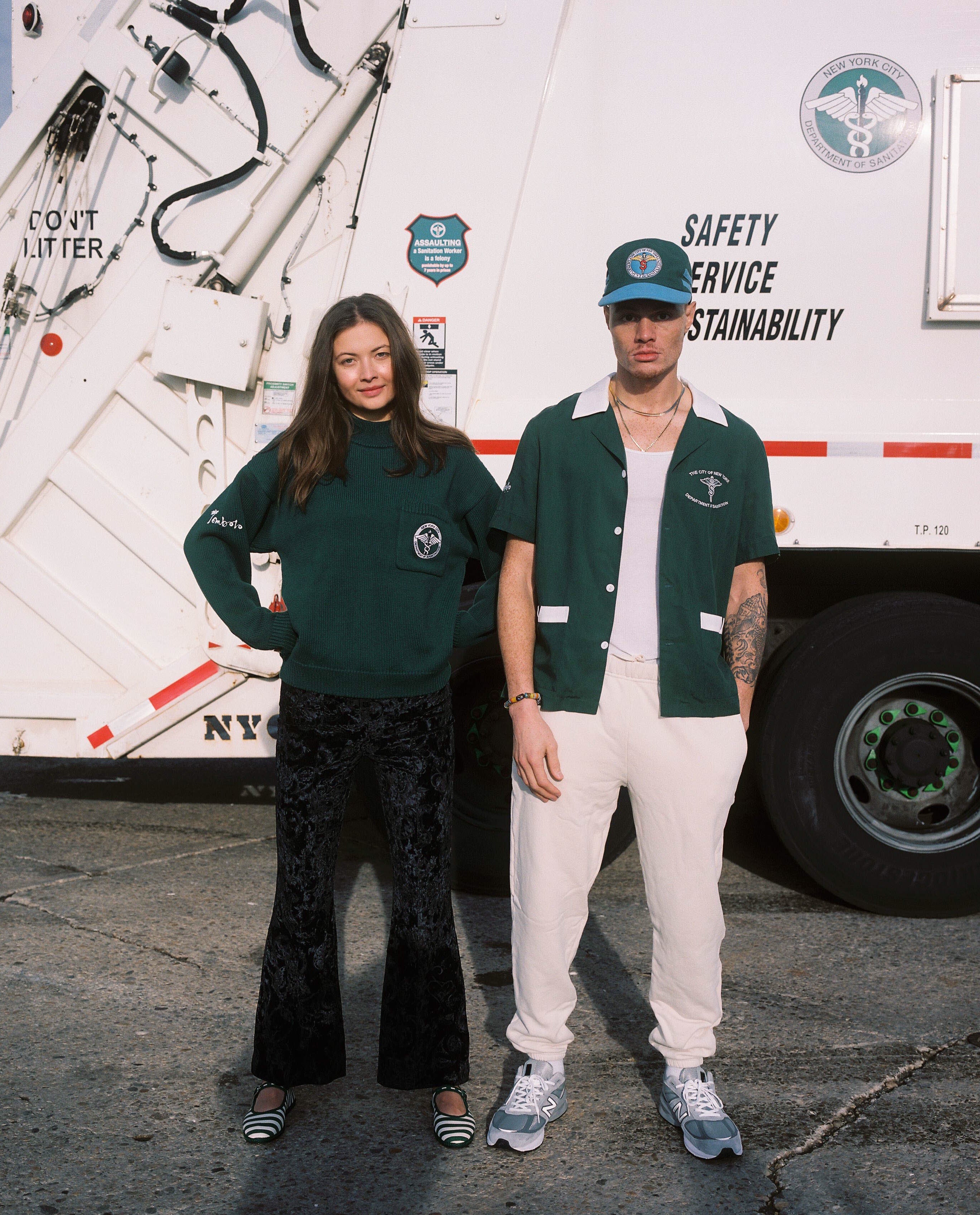 Female model wearing the DSNY x Tombolo sweater next to the male model in the DSNY short and hat