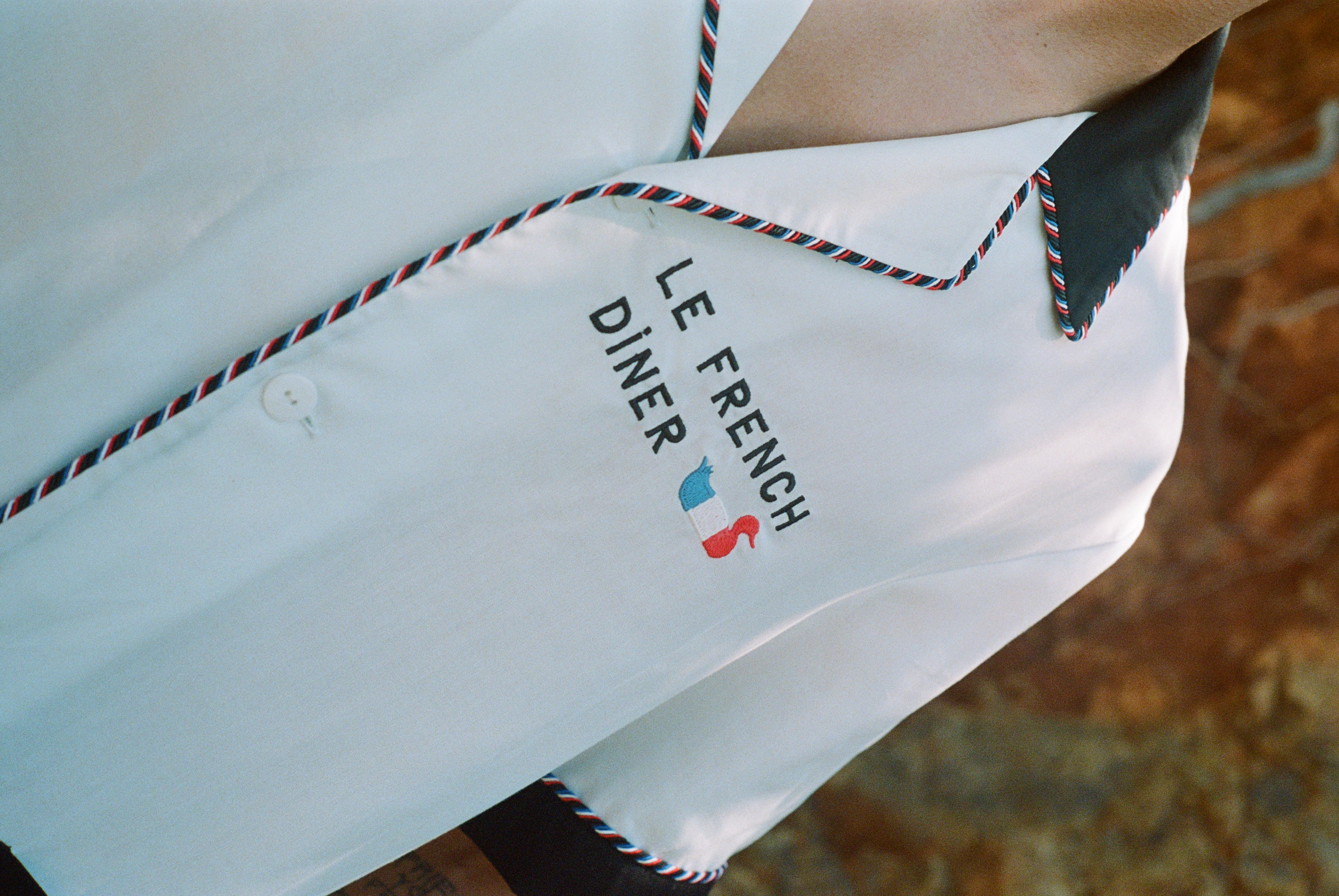 sideways close up of le french diner on shirt