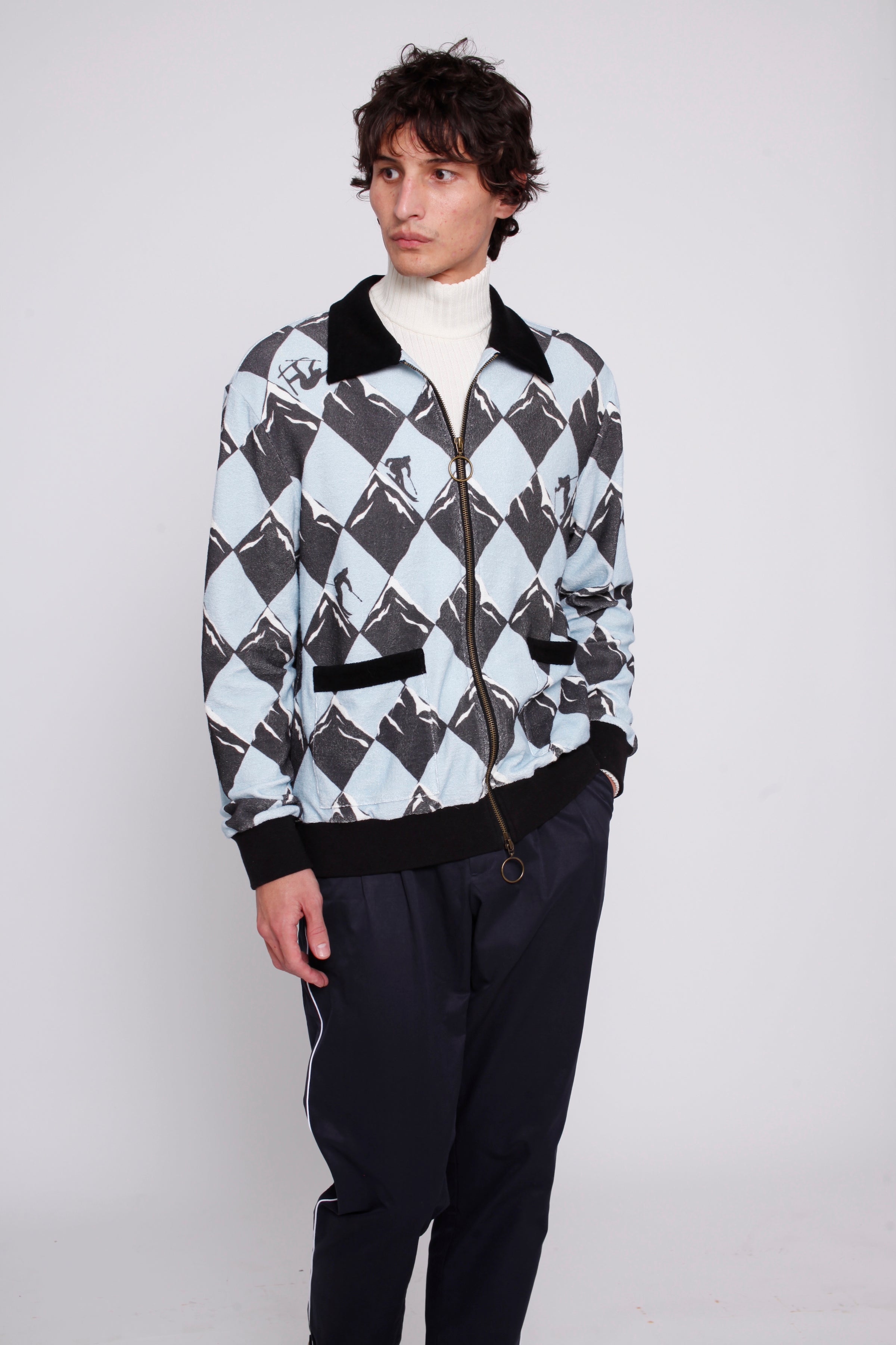 male model in cabana, traveler pants, white turtleneck