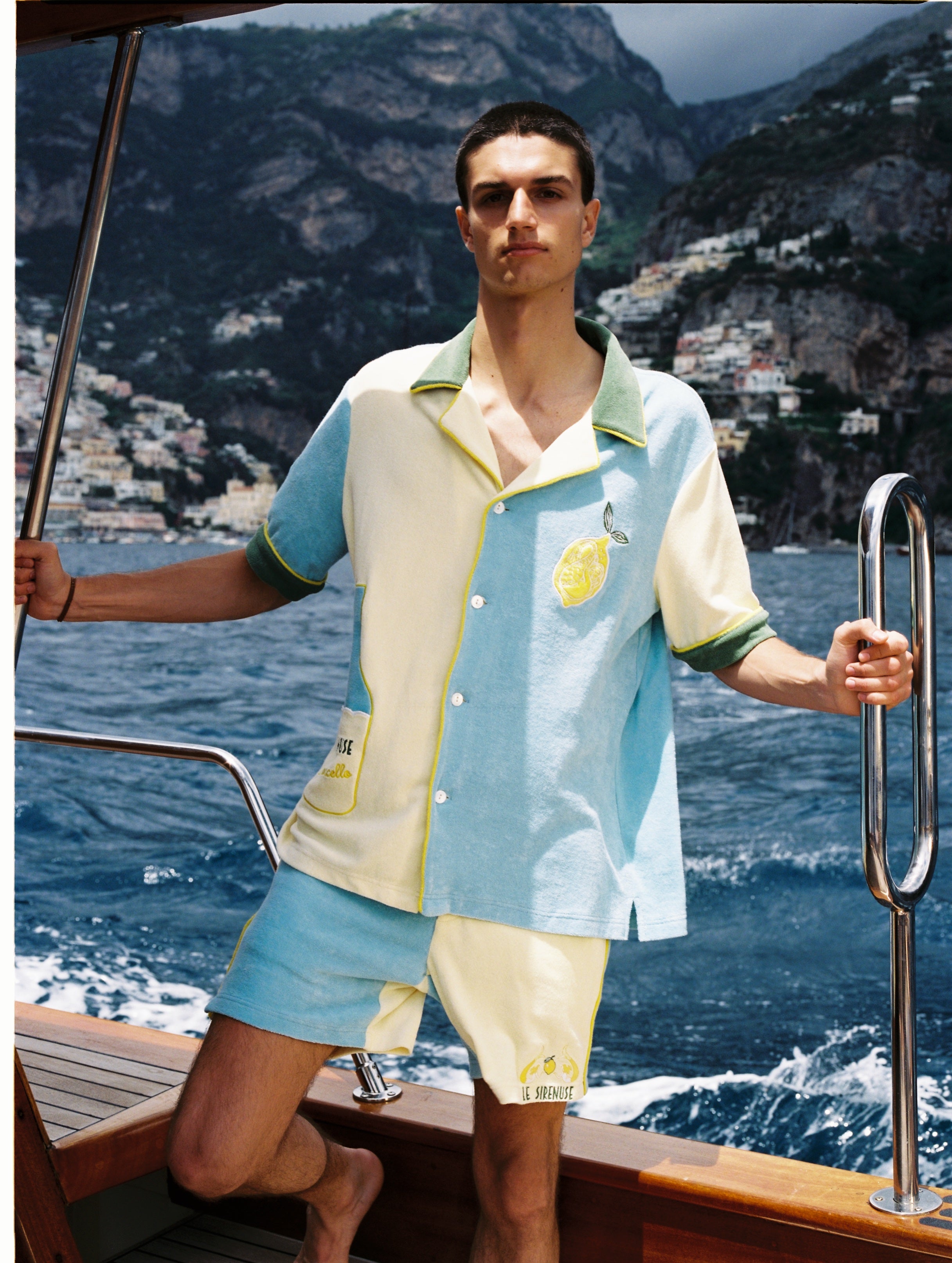 Male model wearing limoncello set on a boat off the coast of positano