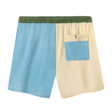 Back view of shorts with blue and yellow colorblocked pocket on yellow pants leg