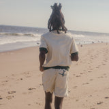 male model running on beach wearing full matching angler set