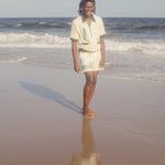 Male model wearing The Angler shirt on the beach with matching shorts