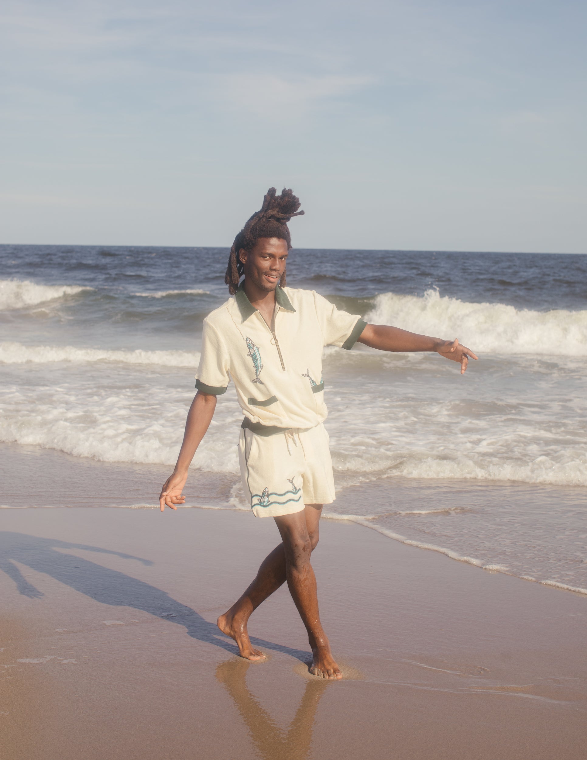 Male model wearing the full angler set dancing on the beach
