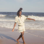 Male model wearing The Angler shirt on the beach with matching shorts