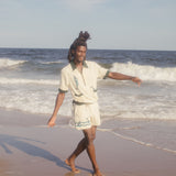 Male model wearing The Angler shirt on the beach with matching shorts