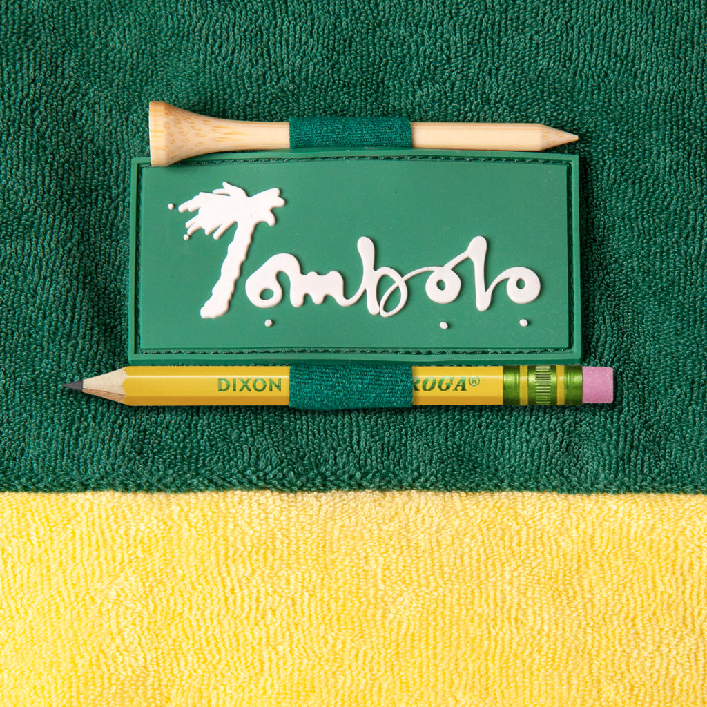 close up of Tombolo patch on sleeve with custom golf tee and pencil holder loops