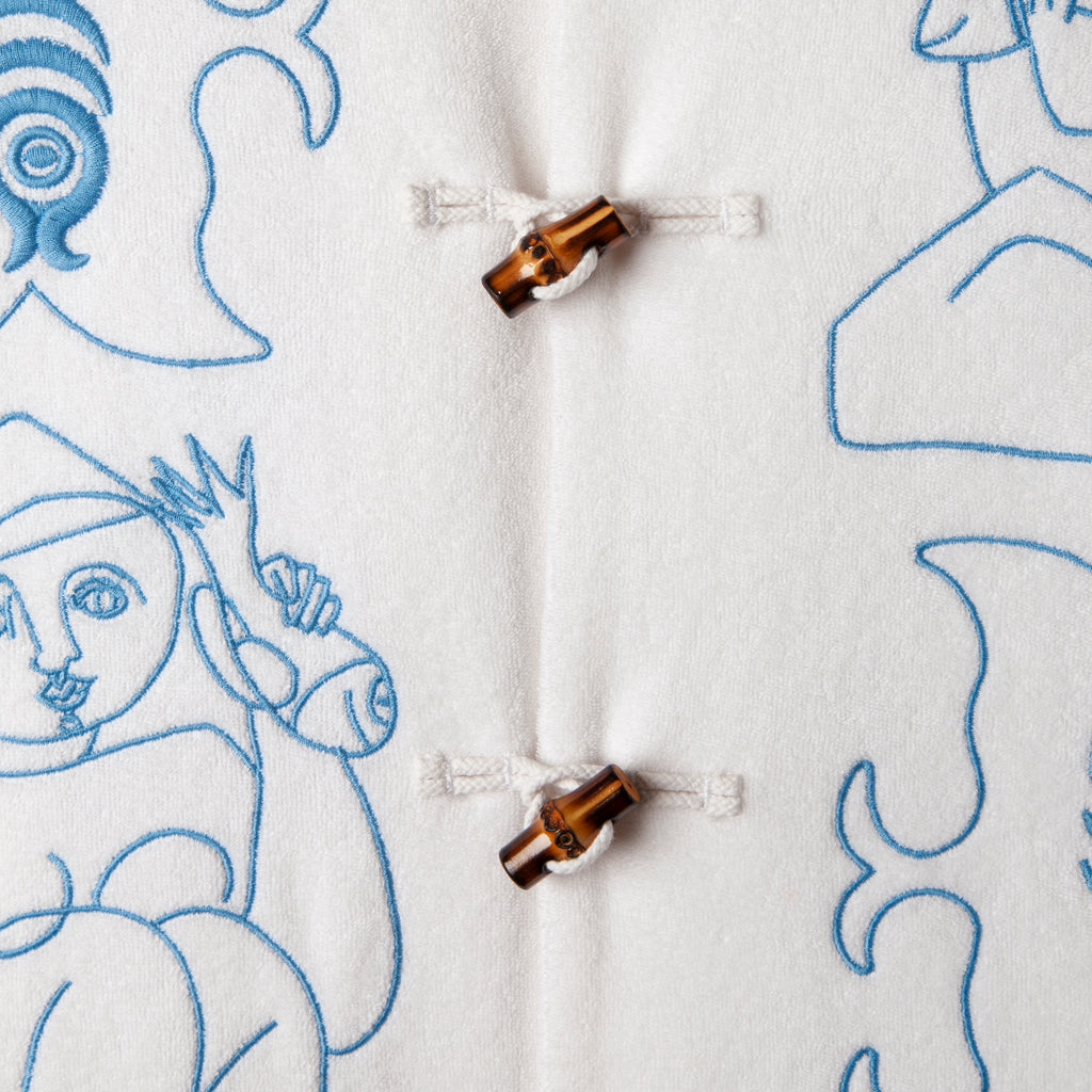 close up of buttons and embroidered figures