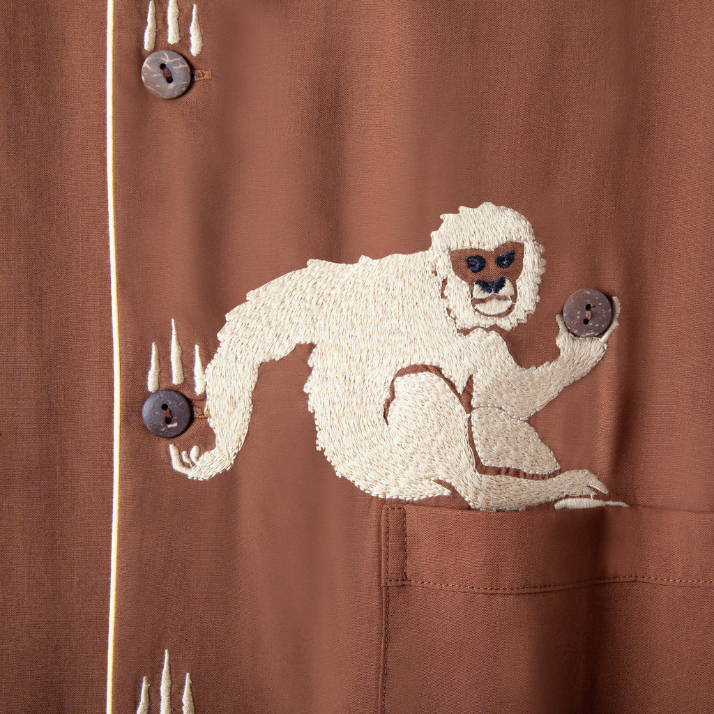 close up of appliquéd monkey catching buttons standing in for coconuts