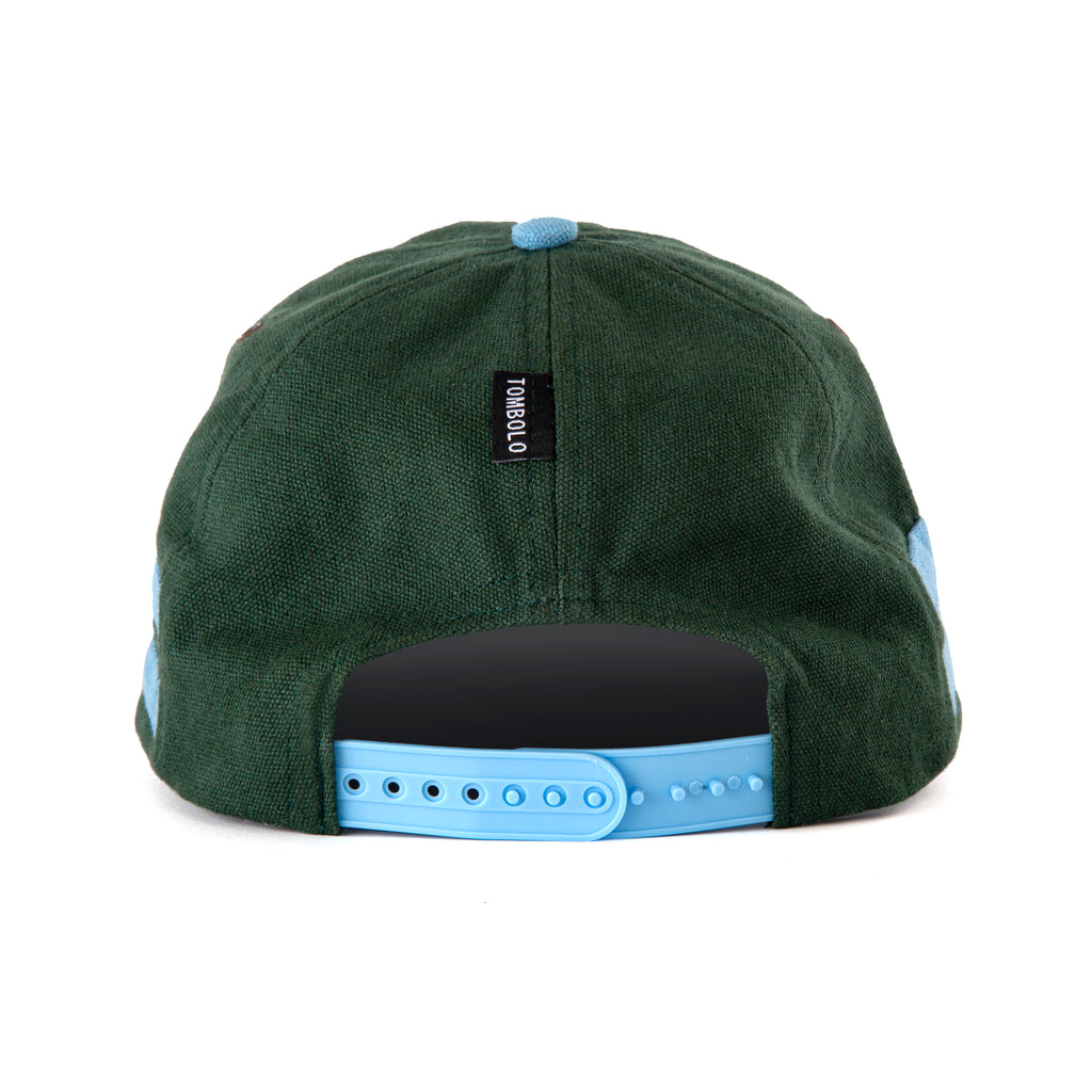 Back view of cap showing the small black Tombolo tag and the light blue snapback fastener